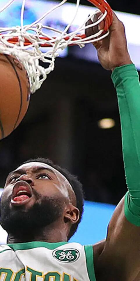 Boston Celtics' Jaylen Brown slam dunks the ball for two points in the first quarter. The Boston Celtics host the New York Knicks in a regular season NBA basketball game at TD Garden in Boston on Dec. 6, 2018